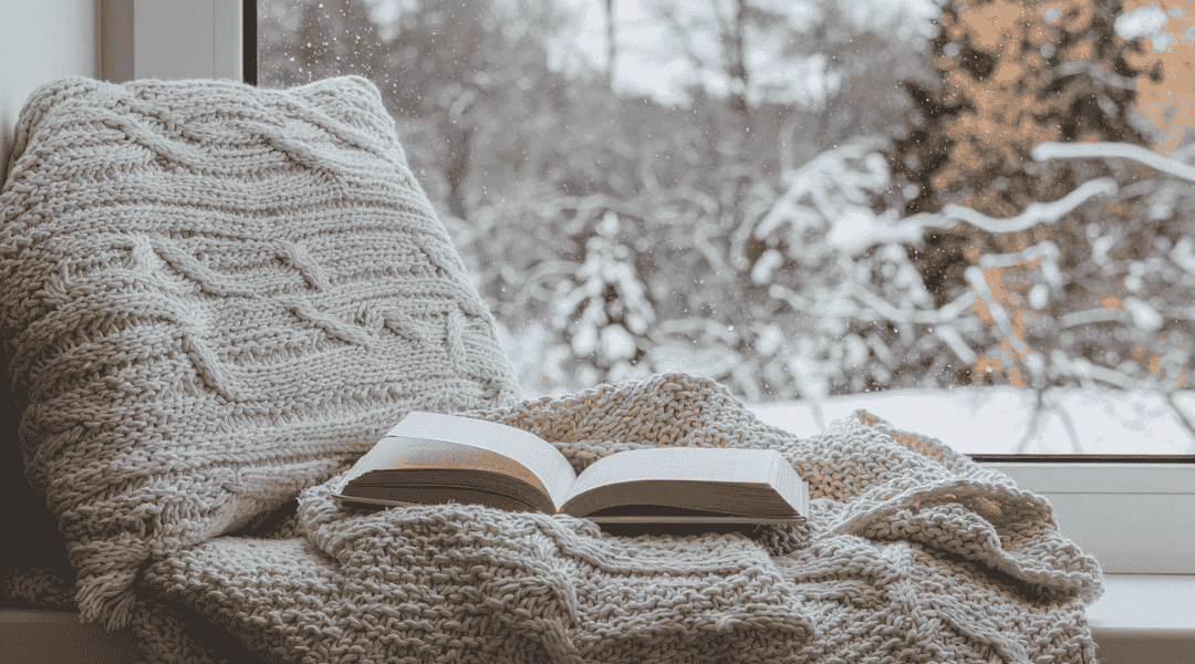 Livre sur les douleurs et le cbd sur un plaid, vue hivernale.